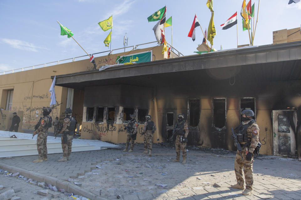 Iraqi army soldiers are deployed in front of the U.S. embassy, in Baghdad, Iraq, Wednesday, Jan. 1, 2020. Iran-backed militiamen have withdrawn from the U.S. Embassy compound in Baghdad after two days of clashes with American security forces. (AP Photo/Nasser Nasser)