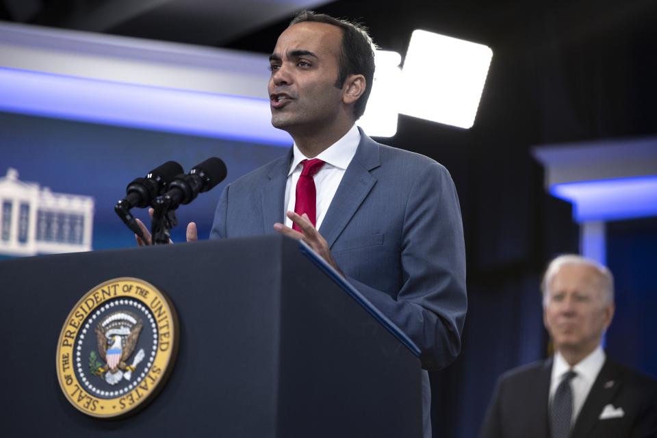 President Joe Biden looks on as Consumer Financial Protection Bureau Director Rohit Chopra speaks during an event inside Southcote Auditorium on the White House campus in Washington.  (Credit: Tom Brenner of The Washington Post via Getty Images)