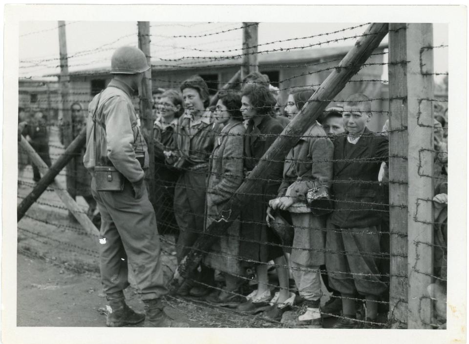 A U.S. soldier greets liberated prisoners at Mauthausen concentration camp, May, 1945.