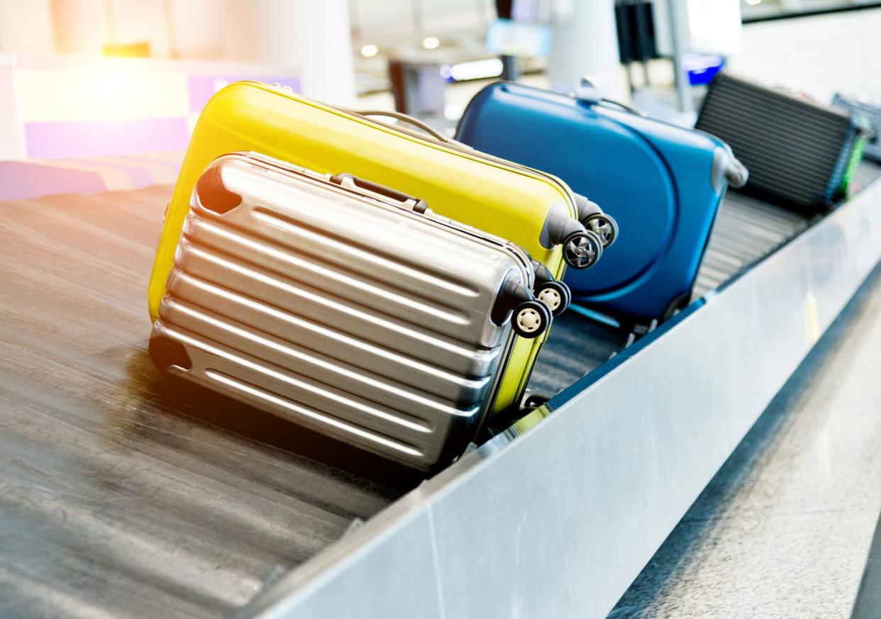 Suitcases on conveyor belt in the airport.