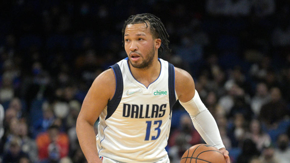 Dallas Mavericks guard Jalen Brunson (13) sets up a play during the first half of an NBA basketball game against the Orlando Magic, Sunday, Jan. 30, 2022, in Orlando, Fla. (AP Photo/Phelan M. Ebenhack)