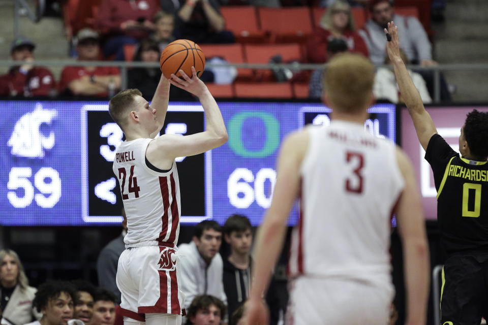 Washington State guard Justin Powell (24) shoots while defended by Oregon guard Will Richardson (0) during the second half of an NCAA college basketball game Sunday, Feb. 19, 2023, in Pullman, Wash. Washington State won 68-65. (AP Photo/Young Kwak)