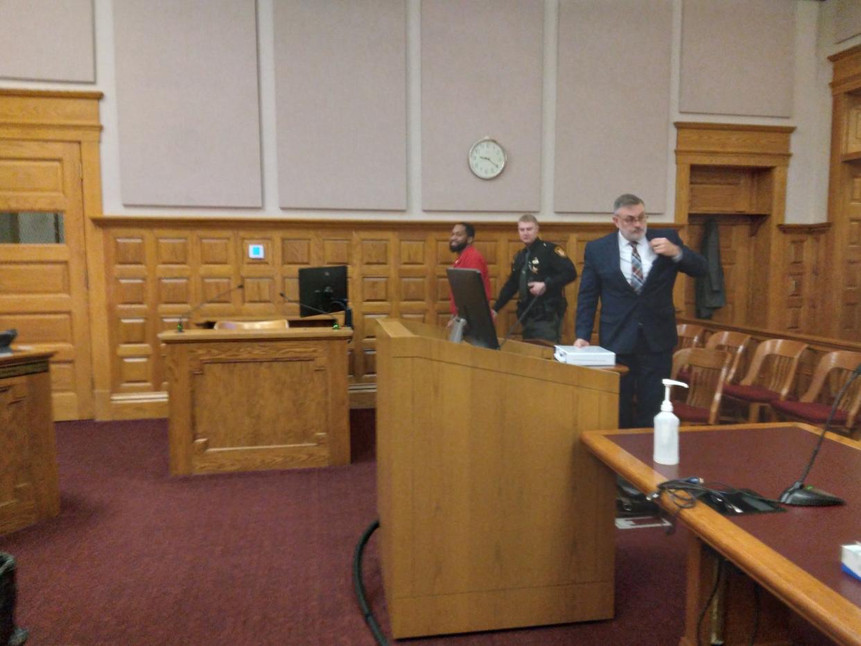 Devion L. Williams, left, is escorted from the courtroom Monday after being sentenced to four years in prison for strangulation and domestic violence by Stark County Common Pleas Judge Natalie Haupt.