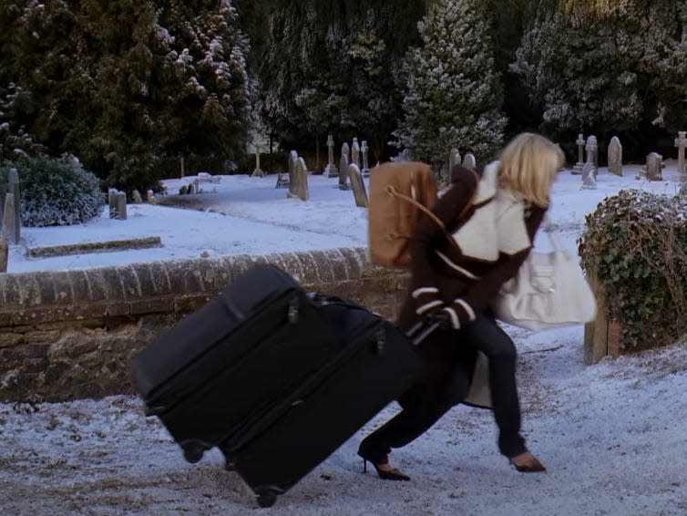 Cameron Diaz as Amanda in "The Holiday" pulling luggage through snow.