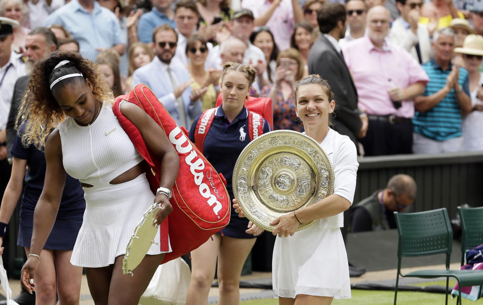 FILE - In this July 13, 2019, file photo, Romania's Simona Halep walks away with her trophy after defeating Serena Williams, left, in the women's singles final match on day twelve of the Wimbledon Tennis Championships in London. (AP Photo/Tim Ireland, File)