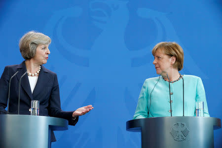 German Chancellor Angela Merkel and British Prime Minister Theresa May address a news conference following talks at the Chancellery in Berlin, Germany July 20, 2016. REUTERS/Hannibal Hanschke/File Photo