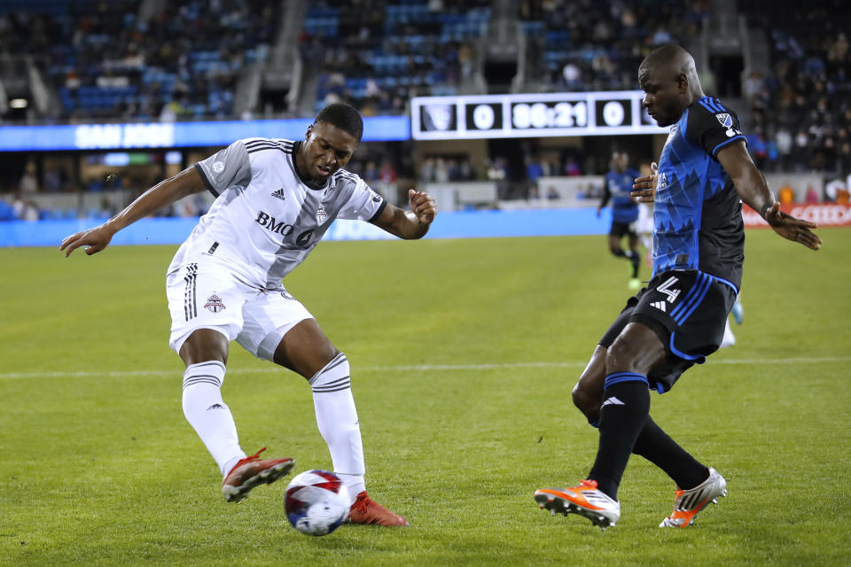 Toronto FC forward Hugo Mbongue, left, controls the ball next to San Jose Earthquakes defender Jonathan Mensah (4) during the second half of an MLS soccer match in San Jose, Calif., Saturday, March 25, 2023. (AP Photo/Josie Lepe)