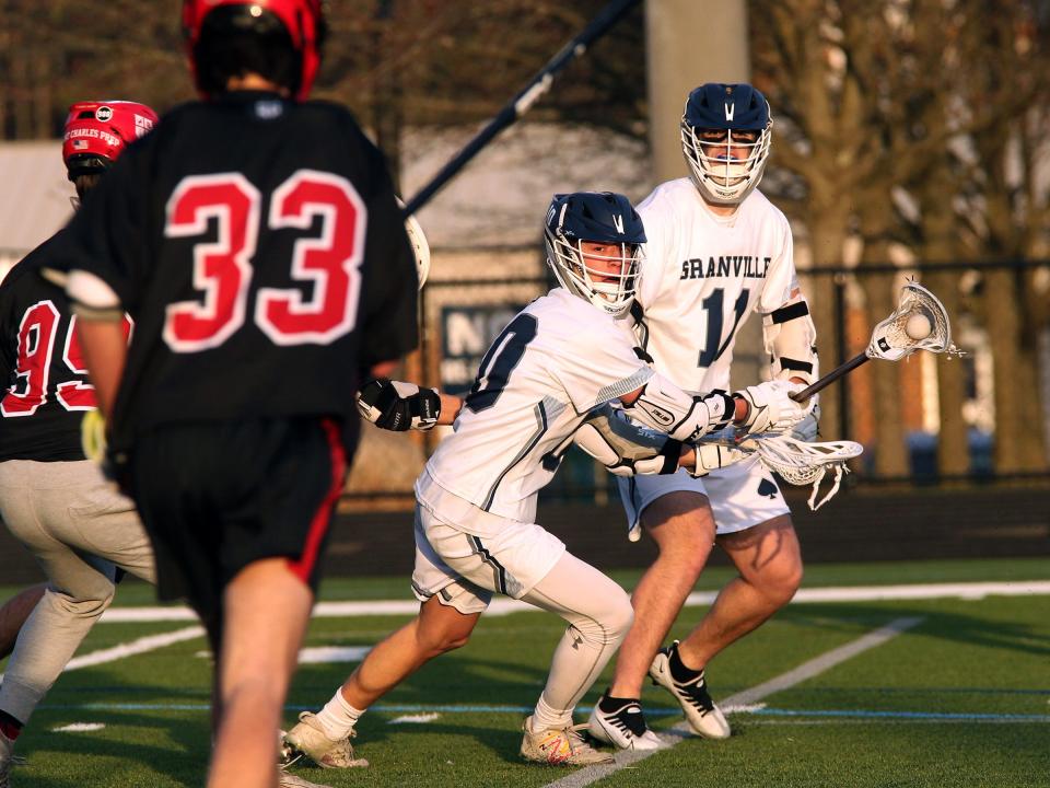 Granville's Elliott Rhoton and Colt Shaw work on offense Tuesday, March 21, during the Blue Aces' 11-10 loss to St. Charles.