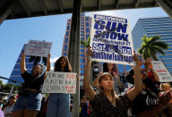 <p>A protester holds a defaced placard at a rally calling for more gun control three days after the shooting at Marjory Stoneman Douglas High School, in Fort Lauderdale, Fla., Feb. 17, 2018. (Photo: Jonathan Drake/Reuters) </p>