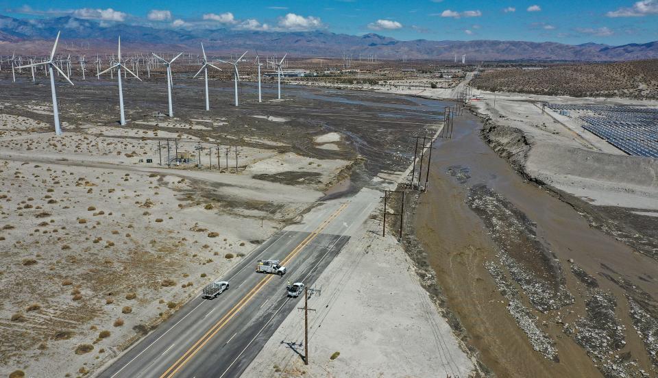 Indian Canyon Drive just south of Interstate 10 is covered in sand, mud and running water Monday in the aftermath of Tropical Storm Hilary.