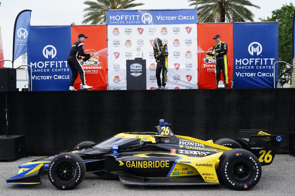 Second place Team Penske driver Josef Newgarden, left, first place Andretti Autosport driver Colton Herta, middle, and third place Team Penske driver Simon Pagenaud celebrate after completing the Grand Prix of St. Petersburg, Sunday, April 25, 2021 in St. Petersburg, Fla. (Luis Santana/Tampa Bay Times via AP)