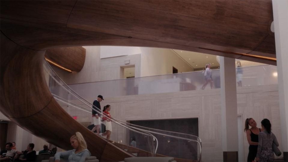 Charlotte and Harry walking down the Waterline Club’s grand staircase. - Credit: HBO Max