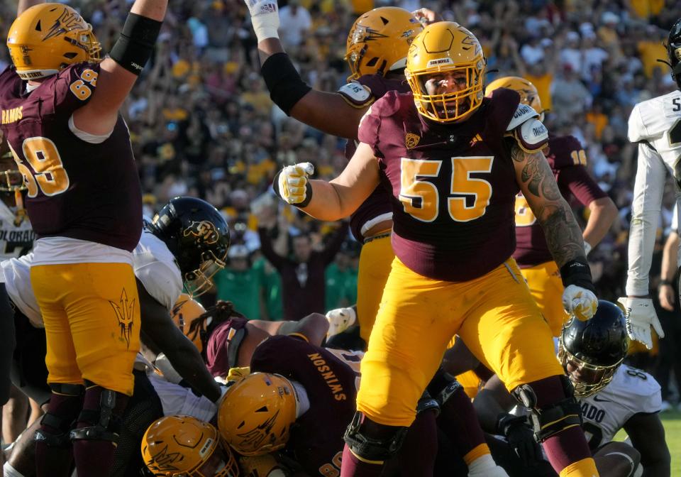 ASU offensive lineman Cade Briggs (55) celebrates a 1-yard touchdown run by Cam Skattebo (4) against the Colorado Buffaloes at Mountain America Stadium in Tempe on Oct. 7, 2023.