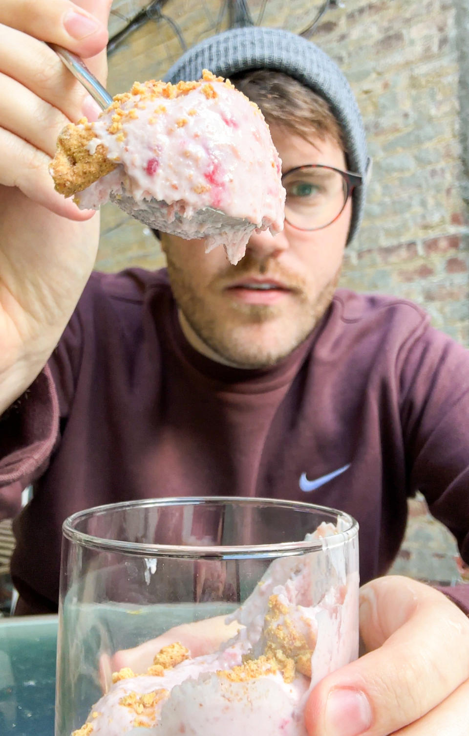 author holding up a large bite of the ice cream up to the camera