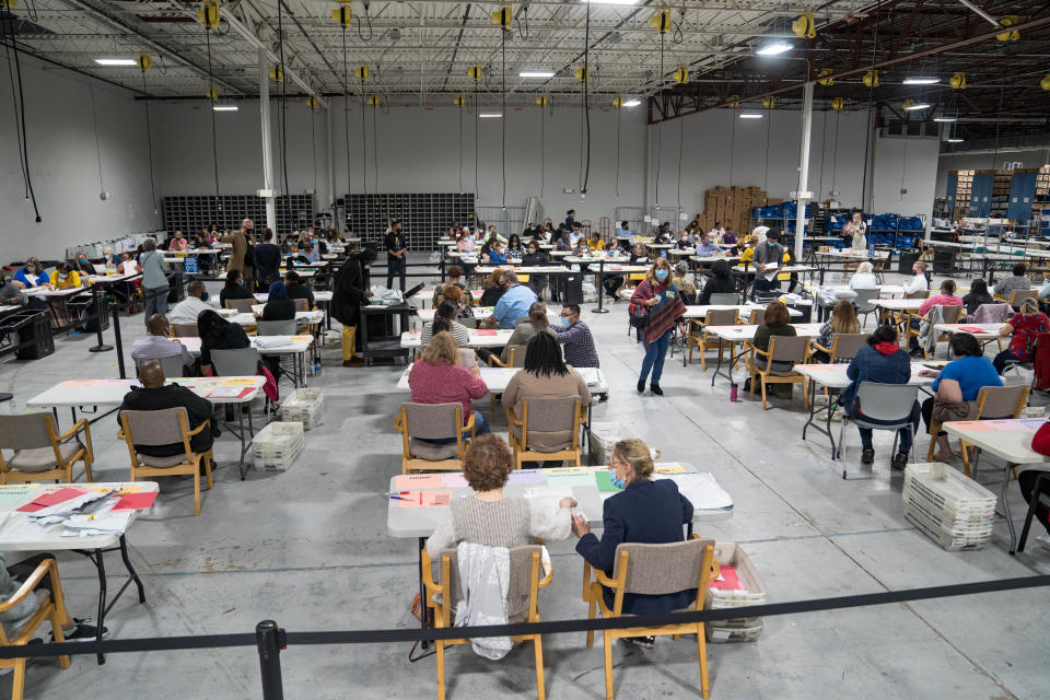 Gwinnett County election workers handle ballots as part of the recount for the 2020 presidential election at the Beauty P. Baldwin Voter Registrations and Elections Building on November 16, 2020 in Lawrenceville, Georgia. (Photo by Megan Varner/Getty Images)