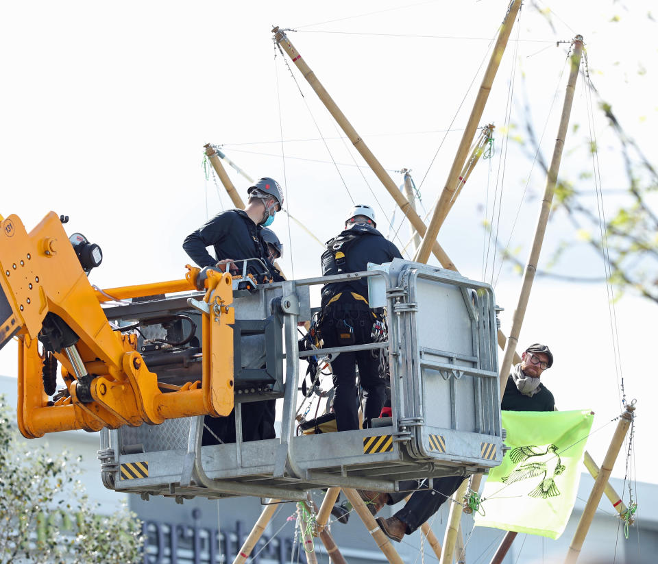 Emergency services use a cherry picker to attempt to remove protesters and dismantle the bamboo lock-ons they are using to block the road outside the Newsprinters printing works at Broxbourne, Hertfordshire. (Photo by Yui Mok/PA Images via Getty Images)