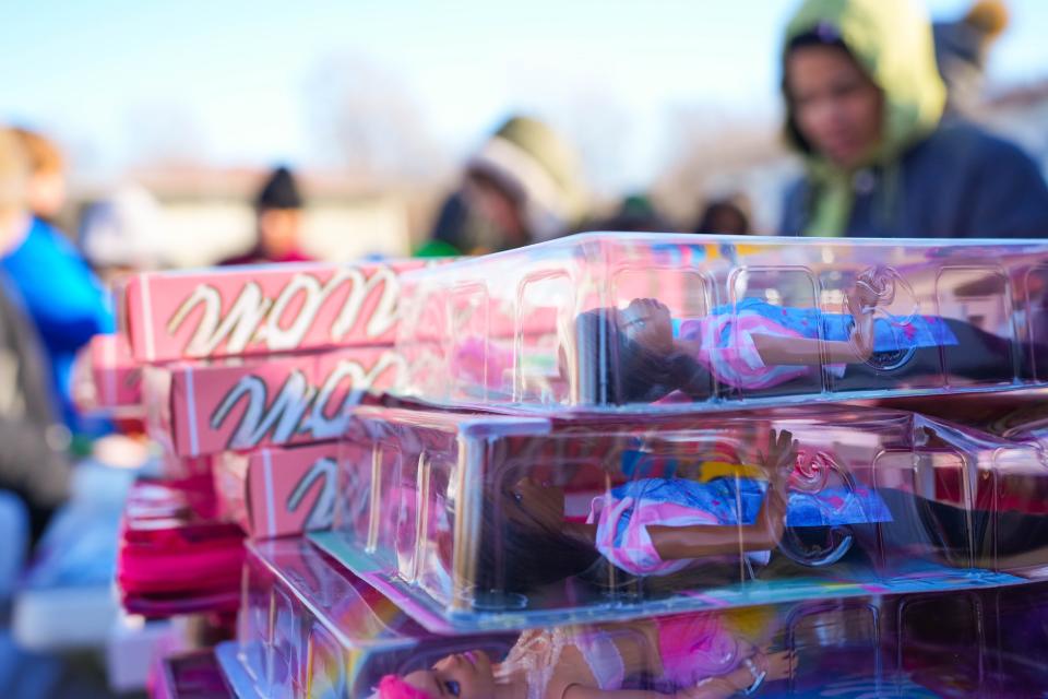 Barbies of all races sit on a table for the Santa Ride event put on by the nonprofit group Refugee Support at the Hickman Flats in Des Moines on Saturday.