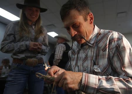 Doug Groves teaches a rawhide braiding workshop at the 31st National Cowboy Poetry Gathering in Elko, Nevada January 28, 2015. REUTERS/Jim Urquhart