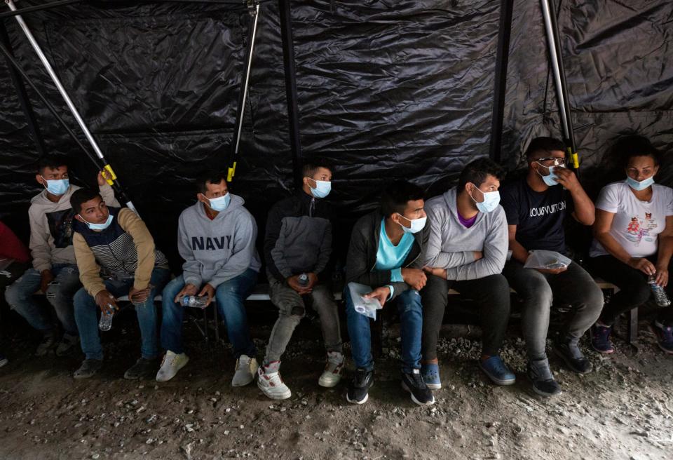 Second from left, Daniel Medina Poche, is processed by Customs and Border Protection  at a mobile processing center in El Paso, Texas after crossing the Rio Grande from Ciudad Juarez on Oct. 17, 2022. Medina was later expelled in Eagle Pass, Texas to Mexico and later transported by Mexican immigration to southern Mexico. 