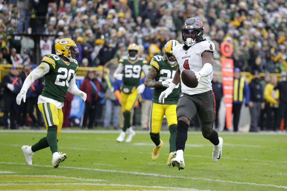 Tampa Bay Buccaneers running back Rachaad White (1) scores on a 26-yard touchdown reception during the second half of an NFL football game against the Green Bay Packers, Sunday, Dec. 17, 2023, in Green Bay, Wis. (AP Photo/Matt Ludtke)