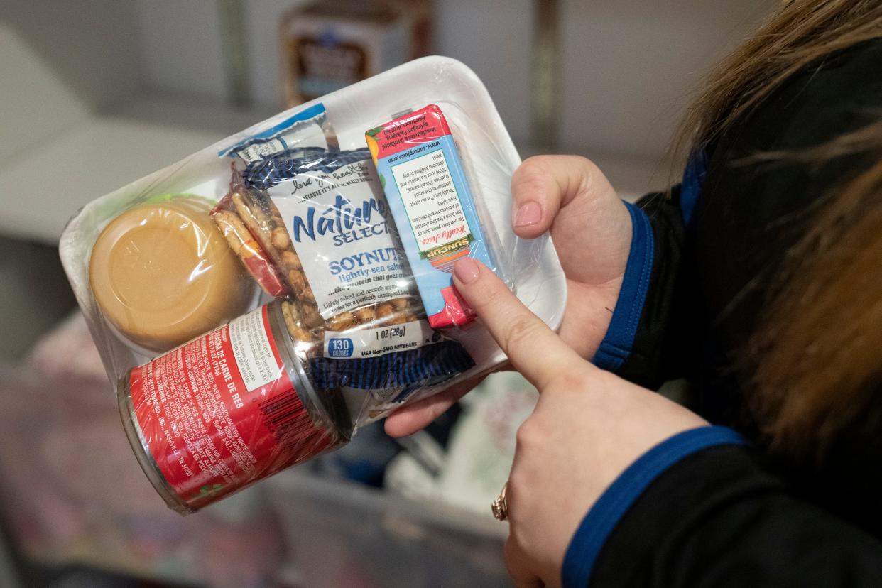 Community Health Worker Mariah Sharpe holds a food kit that is part of the offerings given to new mothers as part of their donation program at the OhioHealth Castrop Health Center in Athens, Ohio. The kit does not require heat in order to prepare the meal.