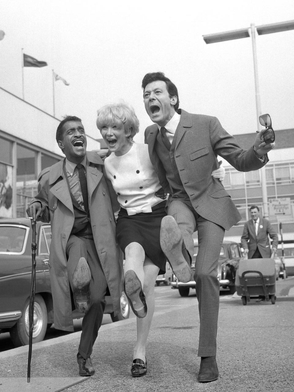 Blair with his younger sister Joyce, an actress, and Sammy Davis Jr at Heathrow Airport in 1966 (PA)