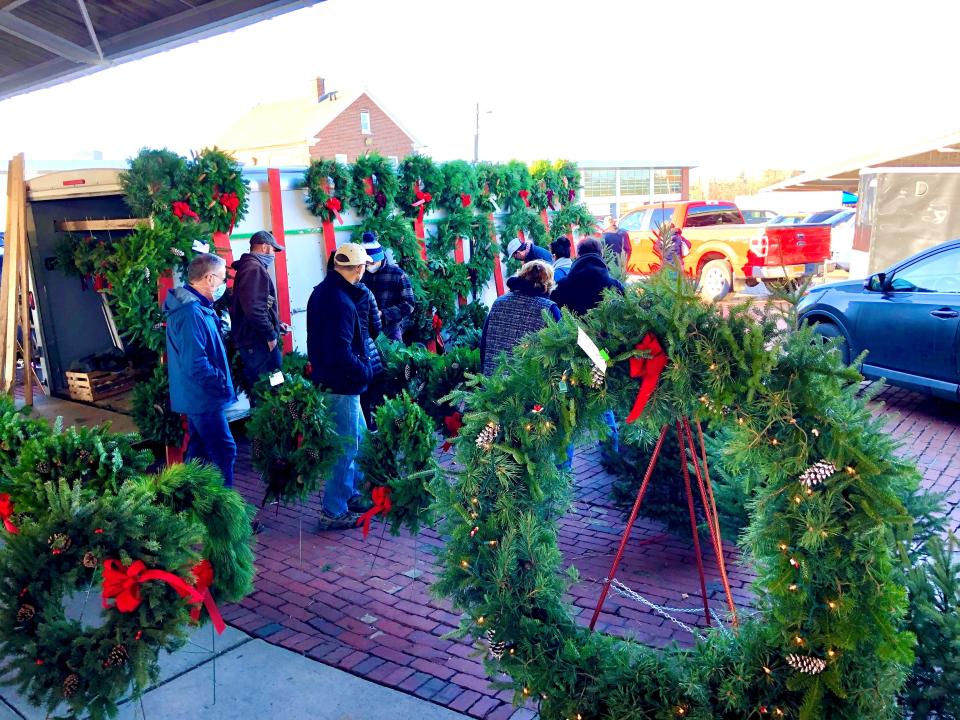 A vendor sells holiday décor at Holidays at the Market at the Rochester Public Market in 2020.