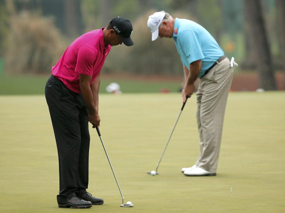 Tiger Woods of the U.S. and compatriot Mark O'Meara (R) putt on the third green during their practice round ahead of the 2015 Masters at the Augusta National Golf Course in Augusta, Georgia April 7, 2015. REUTERS/Brian Snyder