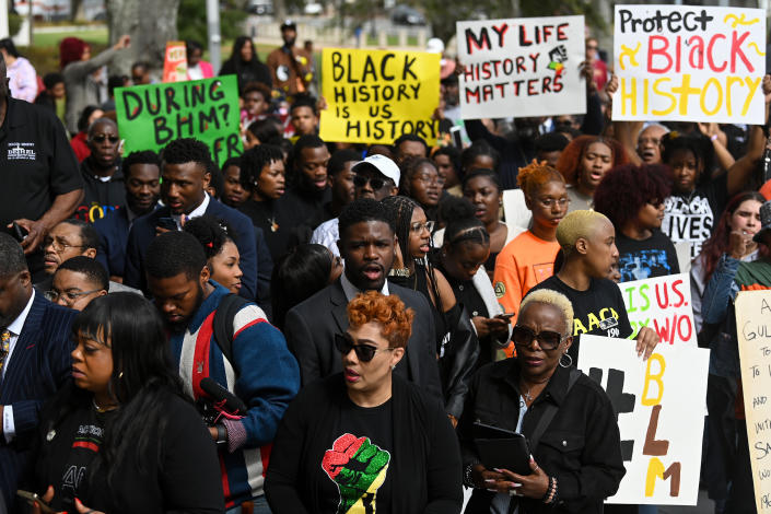 Demonstrators protest Florida Gov. Ron DeSantis' plan to cancel advanced placement courses in African American studies in high schools as they stand outside the state capitol on February 15 in Tallahassee.