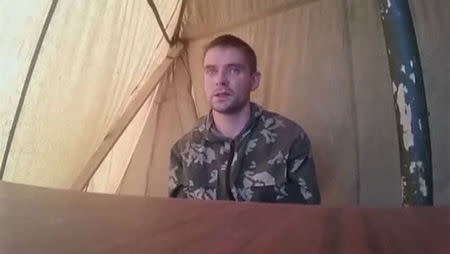 A man who identified himself as Russian serviceman Alexei Generalov speaks in this still image from video released on August 26, 2014 by the Ukrainian Security Service of what it said were Russian soldiers captured on its territory. REUTERS/Ukrainian Security Service via Reuters TV