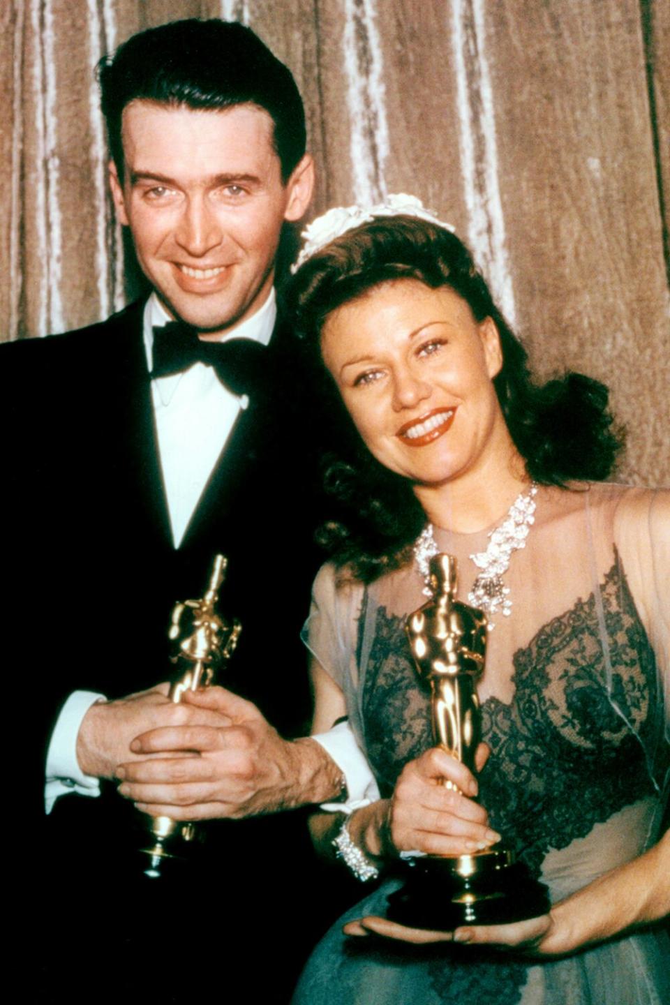 James Stewart (1908-1997), US actor, wearing a black tuxedo, a white shirt and black bow tie, with Ginger Rogers (1911-1995), US actress and dancer, wearing an evening gown, both holding their Oscar statuettes, at the 13th Academy Awards, at the Biltmore Hotel in Los Angeles, California, USA, 27 February 1941. Stewart won Best Actor in a Leading Role for his performance in 'The Philadelphia Story', and Rogers won Best Actress in a Leading Role for her performance in 'Kitty Foyle'. (Photo by Hulton Archive/Getty Images)