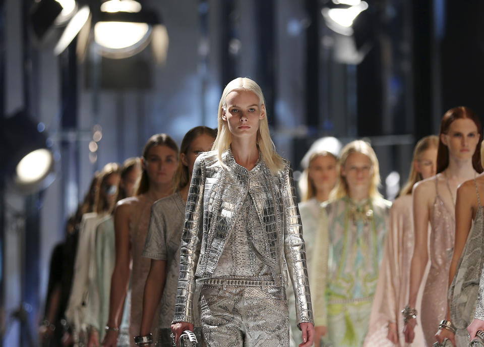 Models wears creations for Roberto Cavalli women's Spring-Summer 2014 collection, part of the Milan Fashion Week, unveiled in Milan, Italy, Saturday, Sept. 21, 2013. (AP Photo/Antonio Calanni)