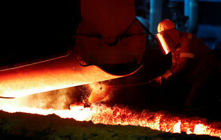 FILE PHOTO: A steel worker of Germany's industrial conglomerate ThyssenKrupp AG which holds it's annual shareholders meeting on Friday February 1, 2019, wears protection helmet as he works near a blast furnace at Germany's largest steel factory in Duisburg, Germany, January 28, 2019. REUTERS/Wolfgang Rattay/File Photo