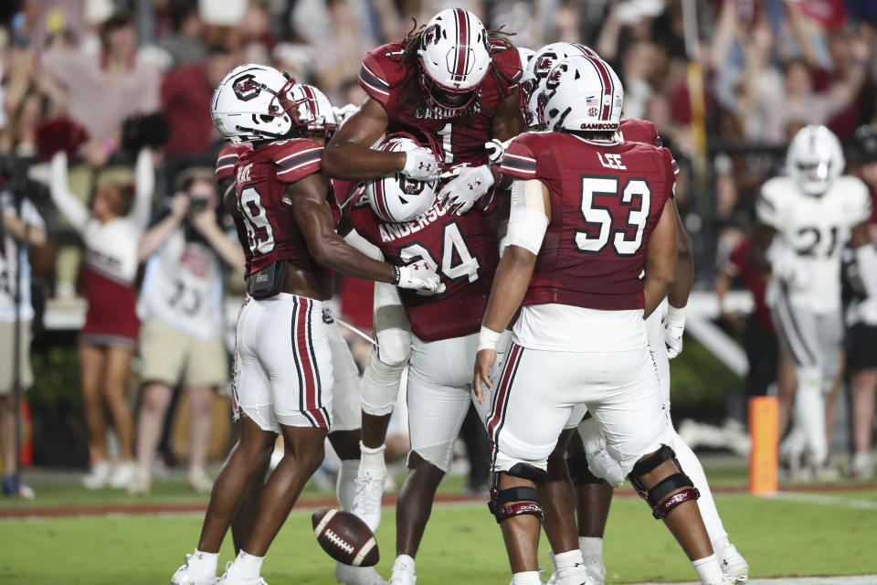 South Carolina tight end Trey Knox (1) is lifted in the air by running back Mario Anderson (24) to celebrate his 17-yard touchdown reception during the first half of an NCAA college football game against Mississippi State on Saturday, Sept. 23, 2023, in Columbia, S.C. (AP Photo/Artie Walker Jr.)