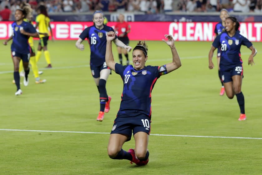 U.S. forward Carli Lloyd (10) slides on the turf after scoring in the first minute against Jamaica.