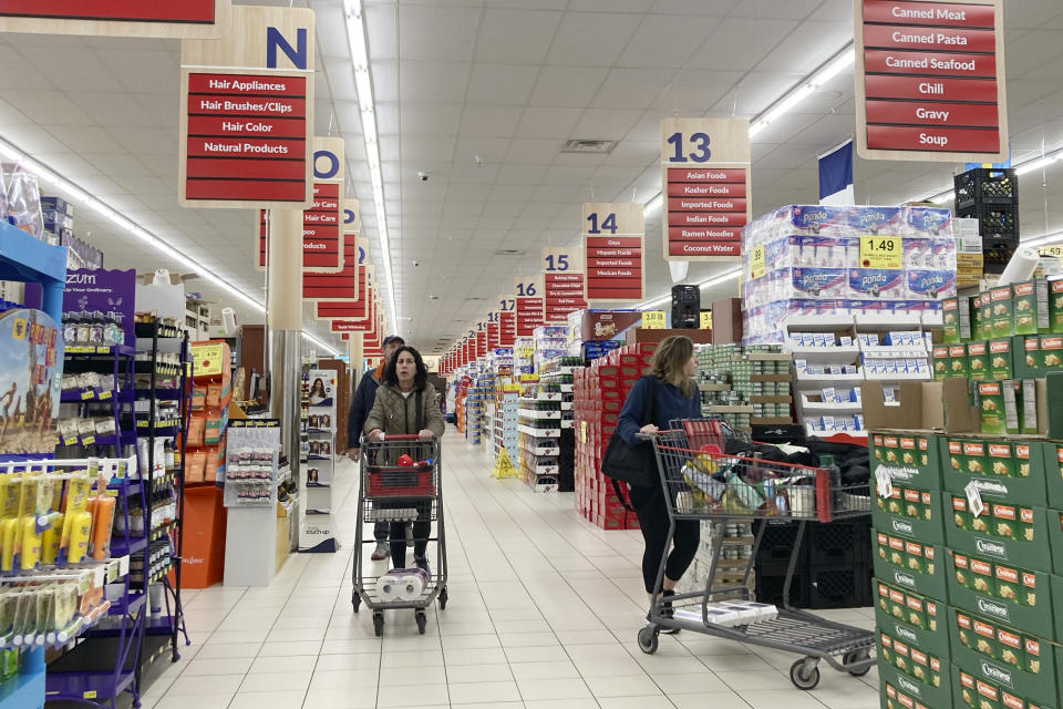 People shop at a grocery store in Buffalo Grove, Ill., Sunday, March 19, 2023. On Tuesday, the Conference Board reports on U.S. consumer confidence for March. (AP Photo/Nam Y. Huh)