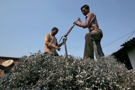 FILE PHOTO: Workers flatten metal scrap on a supply truck at an industrial area in Mumbai, India, November 30, 2018. REUTERS/Francis Mascarenhas/File Photo