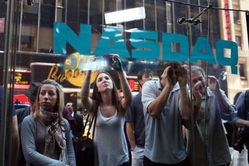 People look into the window of the Nasdaq stock market moments before Facebook shares went public May 18, in New York. Facebook stumbled on its first trading day as shares ended barely above the starting price, raising questions about what will happen to the share price when the Nasdaq reopens on Monday