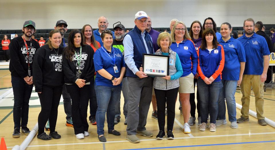 Marty and Vicki Lumm, center, hold a certificate of appreciation for their $11,700 donation, through the Kevin Lumm Memorial Fund, to provide six new inflatable bocce courts for Washington County. They are joined by Washington County Public Schools Unified bocce coaches before the start of the county tournament.