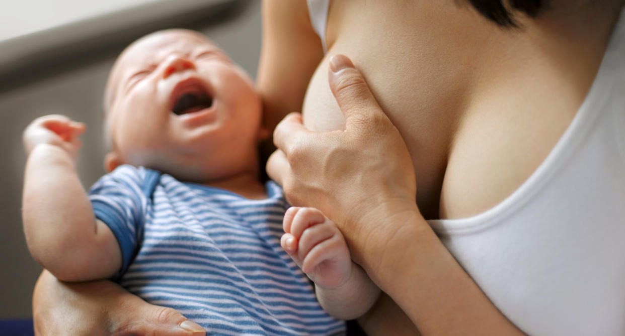 Woman breastfeeding with mastitis