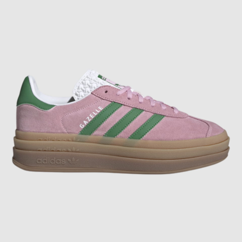 A pink Adidas sneaker with thick light brown soles and green stripe detailing