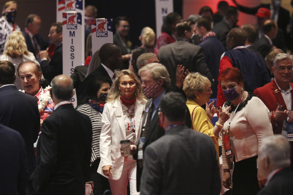 The crowd mingles at the conclusion of President Donald Trump's speech during the first day of the Republican National Convention Monday, Aug. 24, 2020, in Charlotte, N.C. (Travis Dove/The New York Times via AP, Pool)