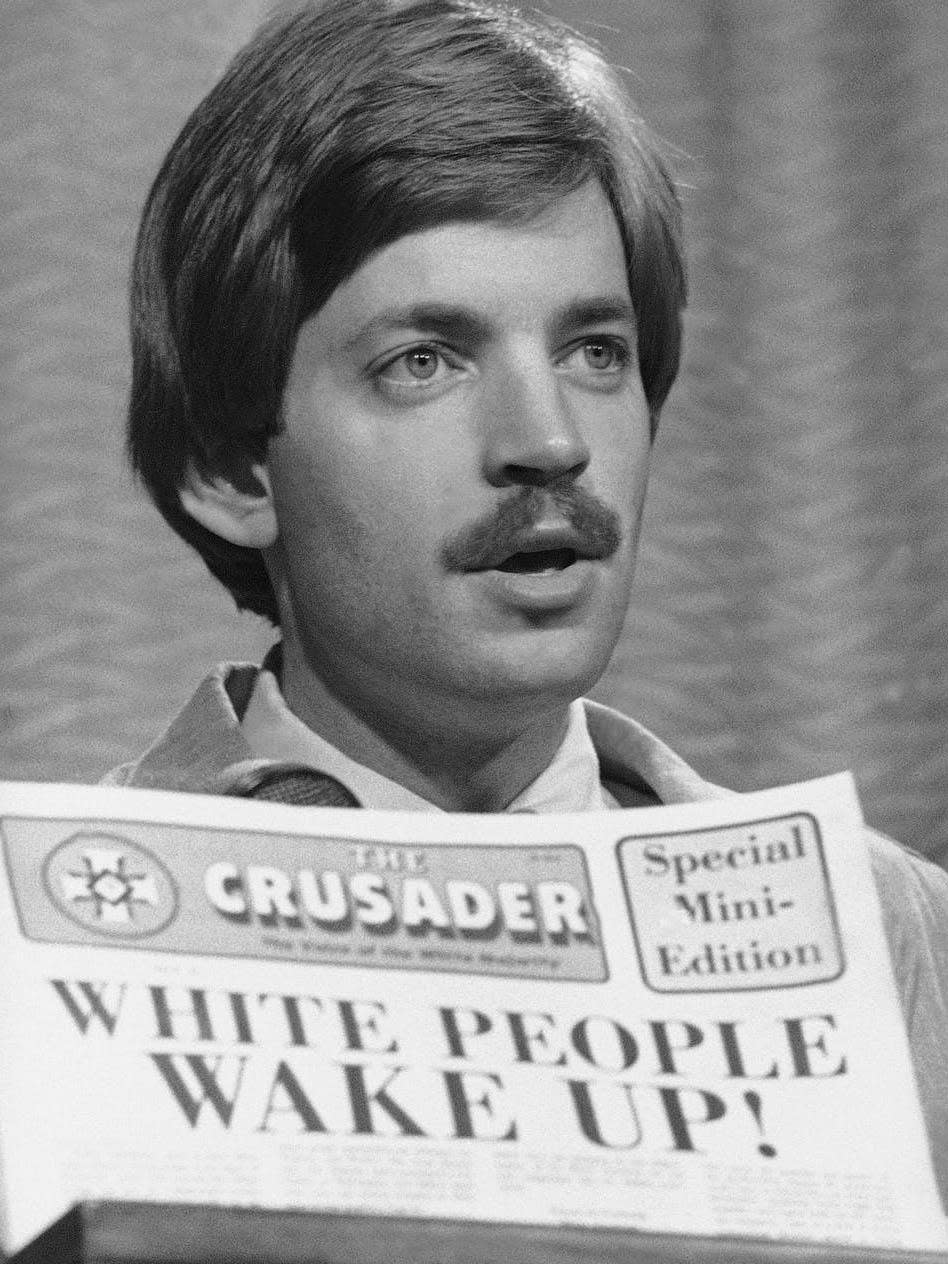 David Duke with the Ku Klux Klan’s newspaper The Crusader in 1977 (AP)