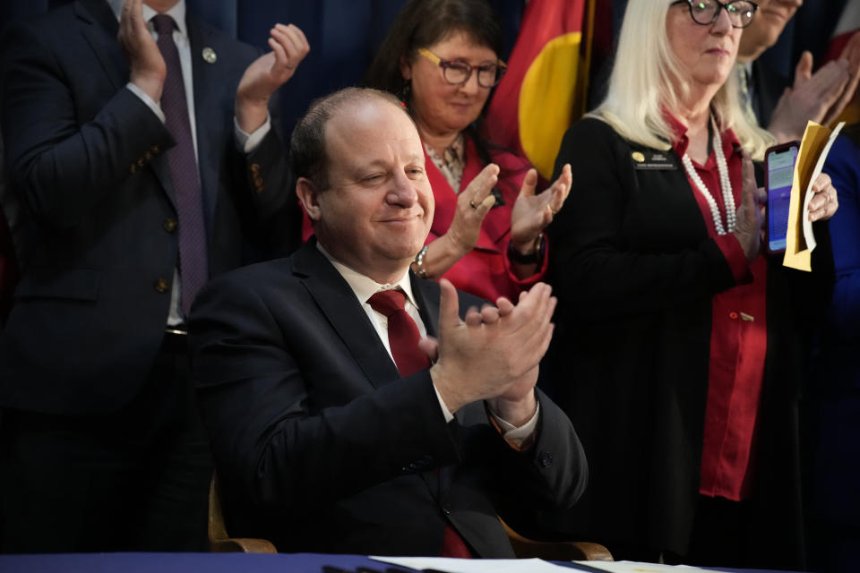 Colorado Gov. Jared Polis applauds a speaker before signing four gun control bill, Friday, April 28, 2023, in the State Capitol in Denver. (AP Photo/David Zalubowski)