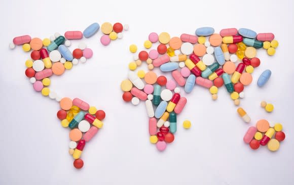 Different pills arranged in shape of world map.