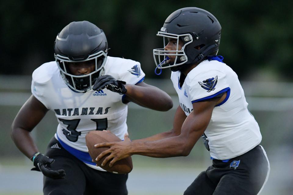 Matanzas quarterback Dakwon Evans (3) hands off the ball to Micah Mcguire (31) during first quarter action. Matanzas traveled to Tocoi High School in Saint Johns County for High School Football Friday evening, September 1, 2023.
