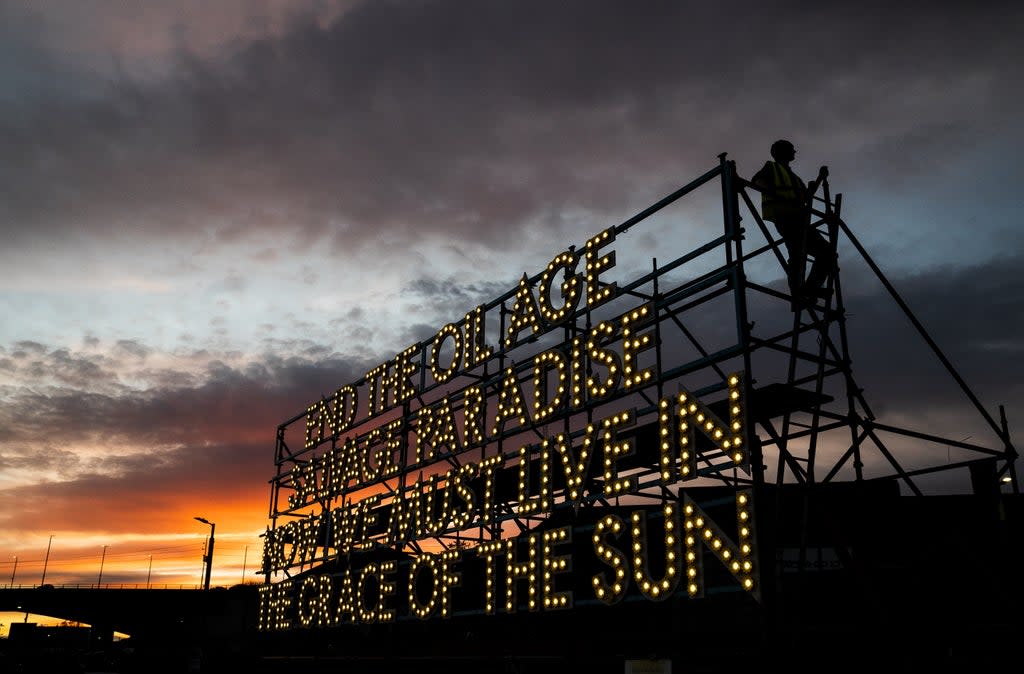 Sunset behind the ‘Grace of the Sun’ a giant solar powered light poem at the Sustainable Glasgow Landing Hub alongside the Glasgow Cop26 campus (Jane Barlow/PA) (PA Wire)