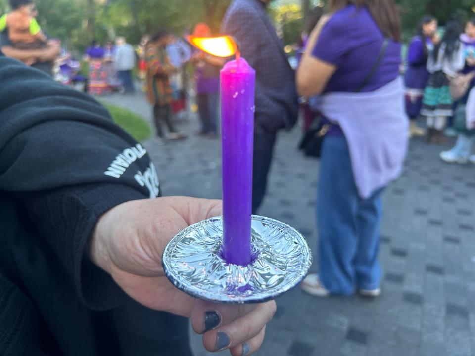 Attendees at the rally wore purple, which was Joyce Echaquan's favourite colour, and lit candles in her honour.