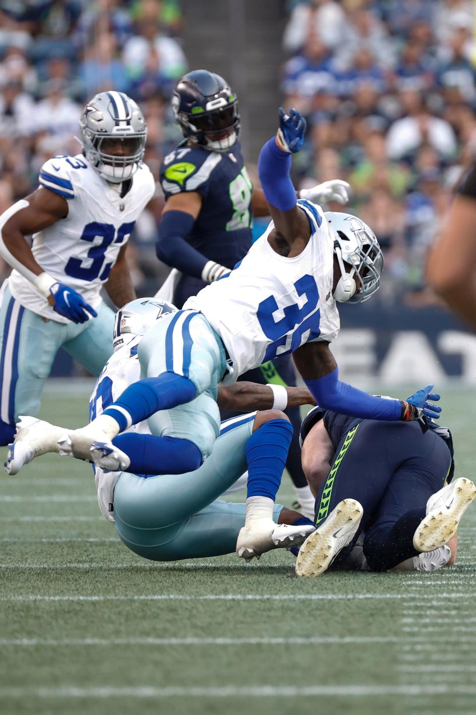 Dallas Cowboys linebacker DeMarvion Overshown (35) tackles Seattle Seahawks tight end Will Dissly (89) after a catch during the first half of an NFL preseason football game, Saturday, Aug. 19, 2023 in Seattle. The Seahawks defeated the Cowboys, 22-14. (James D. Smith via AP)