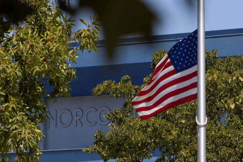 The American flag flies at half-mast outside the high school of Marine Corps Lance Corporal Kareem Nikoui High School following his death in Afghanistan